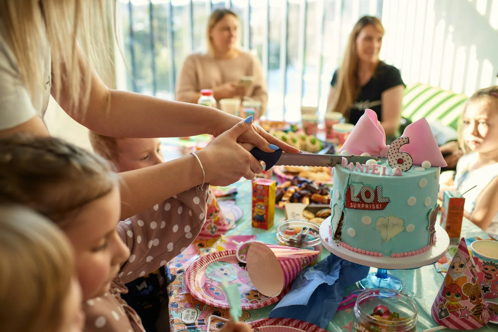 Friends gathered around a birthday table with cake