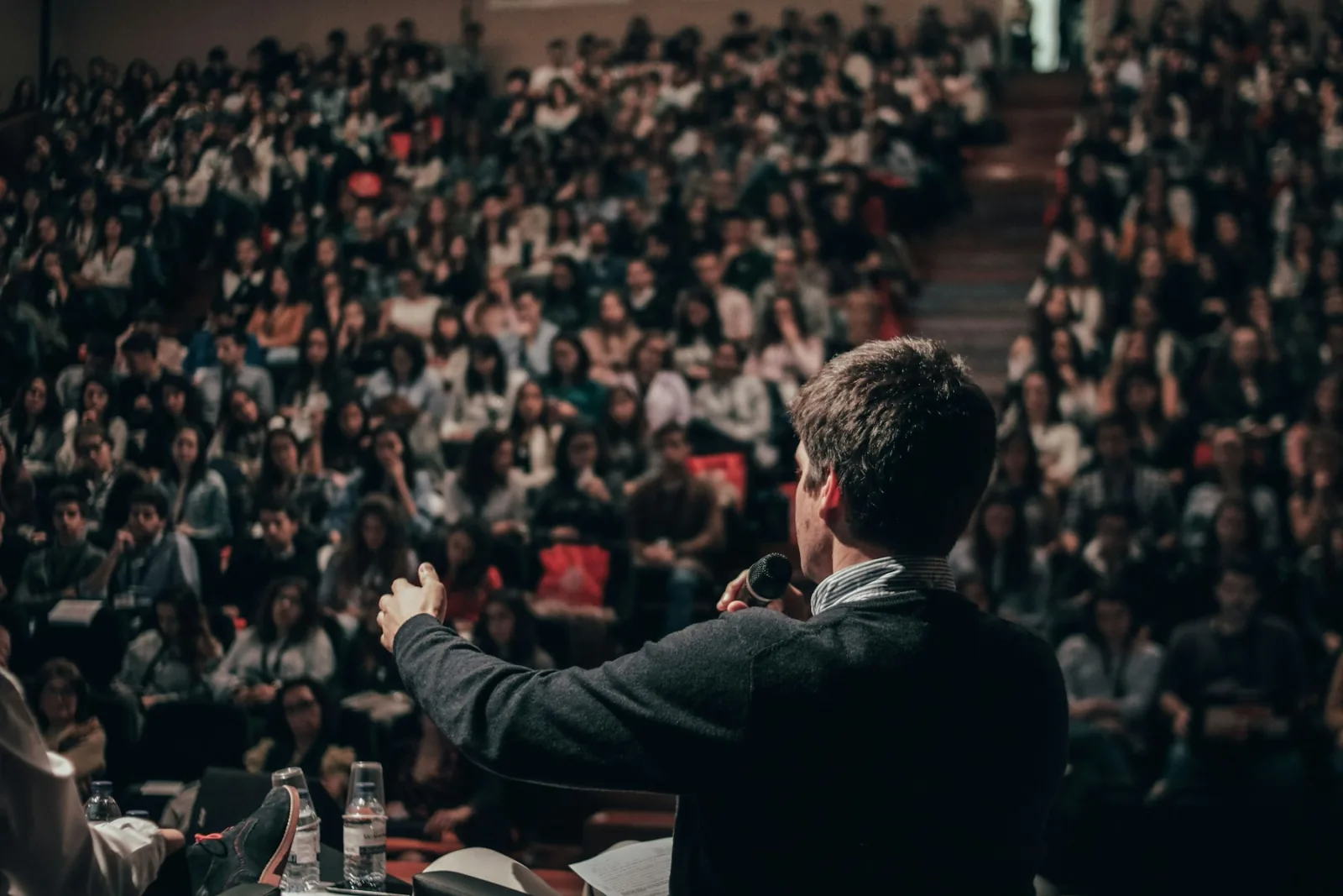 A speaker addressing a full event audience