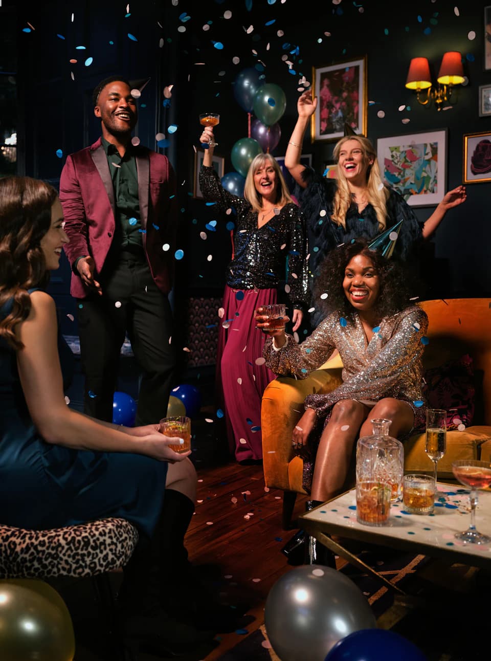 Friends celebrating with confetti and balloons