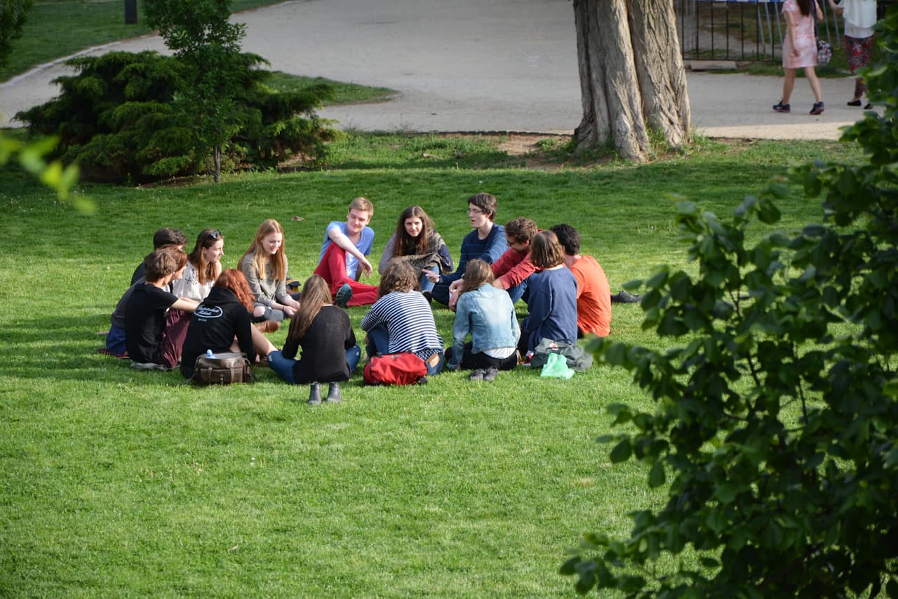A group enjoying a picnic on a green lawn