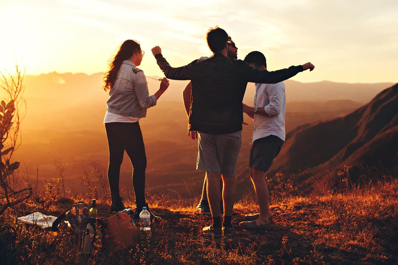 A group of friends looking out from a mountain