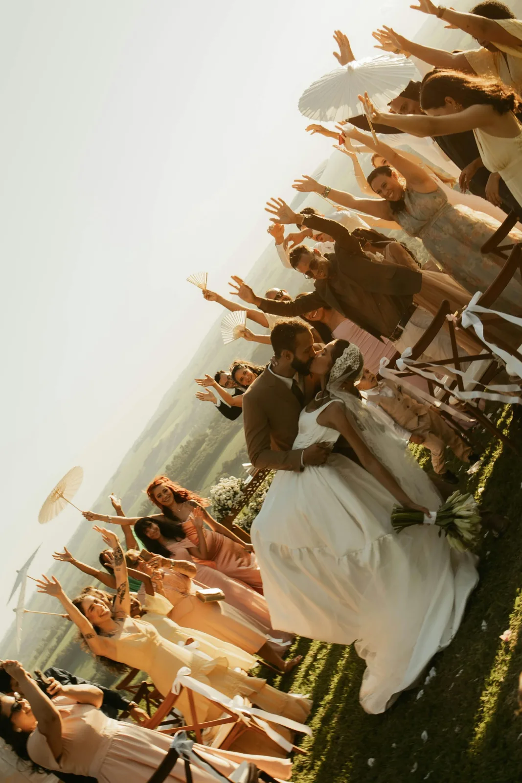 Wedding guests cheering as the couple celebrates
