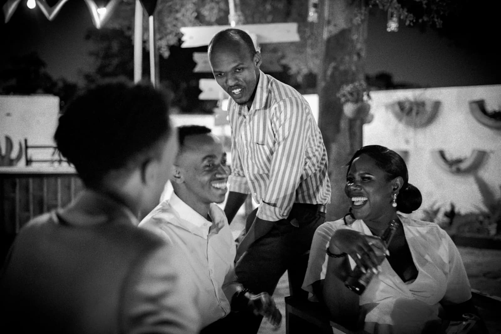 Wedding guests laughing together at a reception